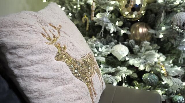 Close view of decorative Christmas cushion with festive reindeer pattern in cozy indoor setting, closeup static