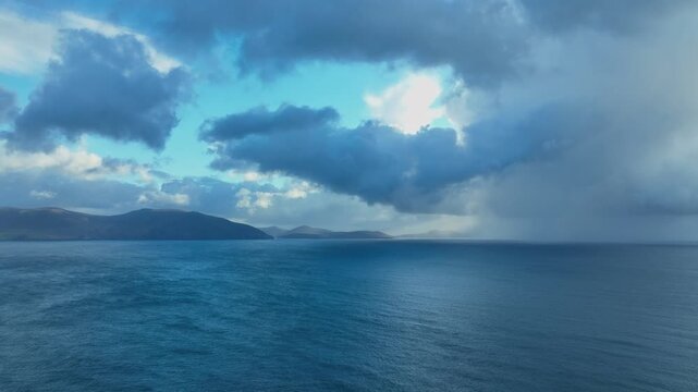Ireland Epic Locations dramatic skies over Kenmare Bay and Kerry Mountains with rain showers