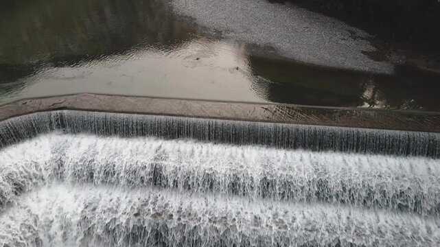 Drone pushes forward into Lechfall's towering tiered dam in Fussen, immersing in massive whitewater sheets crashing down rocky gorge. Thrilling Bavarian waterfall intensity.