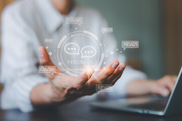 Businessman showing virtual feedback icon with speech bubbles. Customer review, satisfaction survey concept. Digital service evaluation and client opinion analysis strategy.