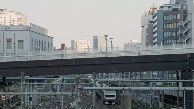Tokyo Scene : Elevated Pedestrian Walkway Runs Above Trains That Cross Multiple Tracks, Forming a Layered Urban Structure  |  Shinjuku Southern Terrace, Tokyo, Japan