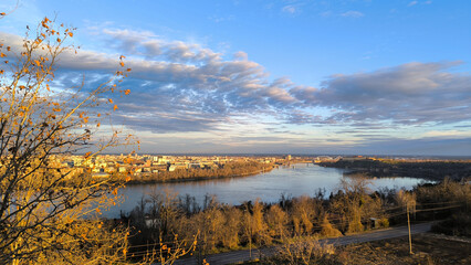 colorful sky at sunrise with dramatic clouds over the Danube river with view at Petrovaradin Fortress