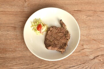 grilled pepper Ribeye beef steak and chop vegetable salad on plate 