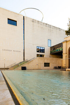 Vienna, Austria, October 16, 2025 - Large shallow water basin in the museum quartier, with the facade of the Leopold Museum in the background