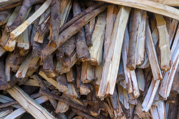 Natural firewood sticks forming a rustic wooden texture background. Organic and eco-friendly wood surface suitable for design, banners, wallpapers, and background use.
