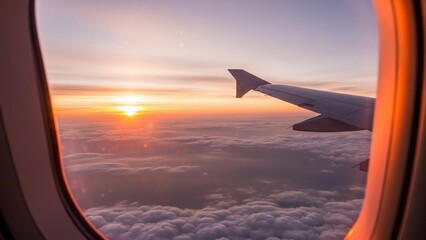Obraz premium Stunning view of sunset from an airplane window over a sea of clouds.