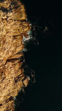 High cliff and dark blue ocean along the coast near Fisterra, Spain