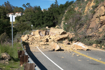 Rock slide boulders blocking canyon Road in the Chatsworth neighborhood of Los Angeles California.  