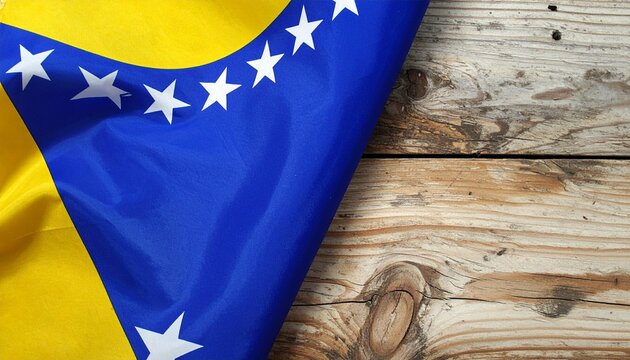 A flag with a blue field, a yellow right triangle in the upper right corner, and white stars diagonally along the triangle&rsquo;s hypotenuse, displayed against a white background, representing Bosnia and H