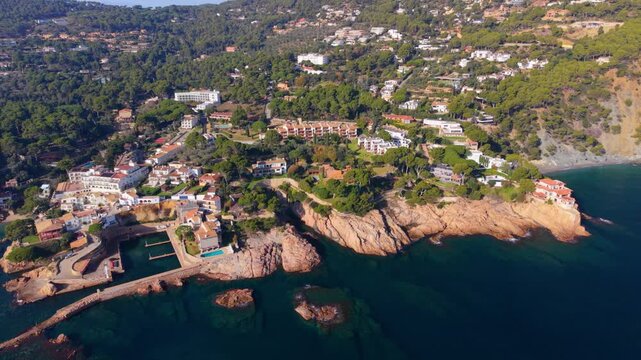 Beautiful aerial perspective of the charming coastal village of fornells de mar, highlighting its picturesque coves, rocky shoreline, and the turquoise waters of the mediterranean sea