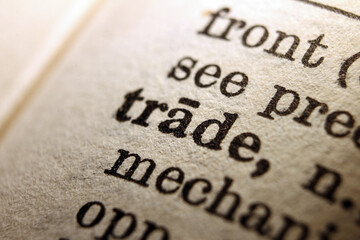 Word trade printed on dictionary page, macro close up