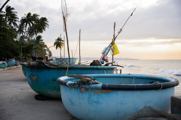 Vietnam traditional basket boats on tropical beach at sunrise
