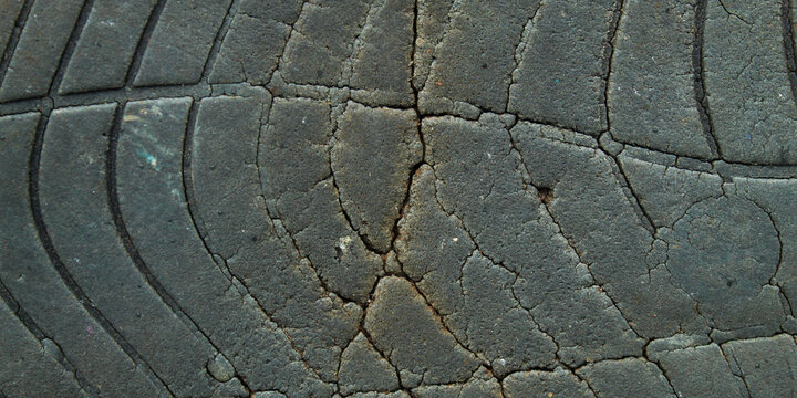 Detail of the surface texture of a rubber tire that has experienced oxidation damage.