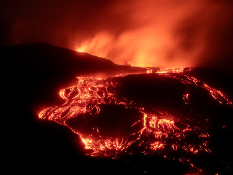 Mount Etna, lava flow during volcanic eruption at night - Powered by Adobe