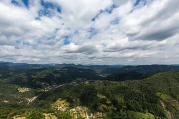 Naklejka premium Mountain and forest with dramatic cloudy sky