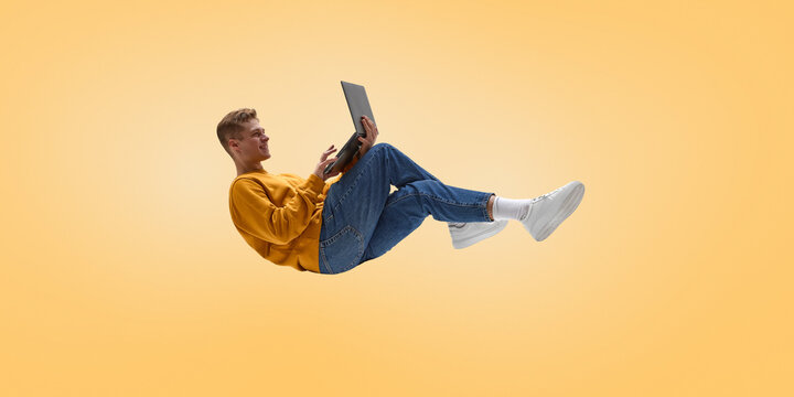 Freelance professional working remotely on laptop in floating relaxed pose. Concept of independent remote work, flexible schedule, digital tools, productivity outside office, calm focused mindset.