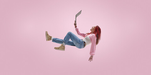 Remote freelancer floating while managing projects on laptop. Concept of project based work, async...