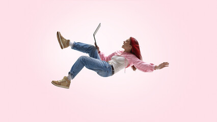 Young freelancer working remotely with laptop in mid air. Concept of location independent work, creative freedom, digital services, modern self employed career path.