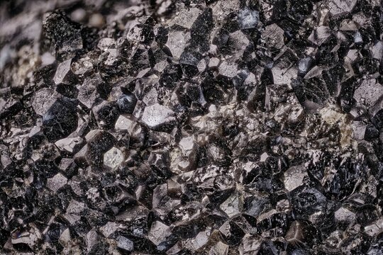 Black Olivine - macro texture hortonolite. Crystals on rock, Kola Peninsula, Russia