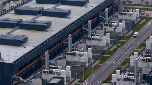 Aerial view of the Agriport data center's cool-toned architecture against the muted sky, reflecting modern industrial efficiency, Data Center Agriport, Middenmeer, Netherlands.