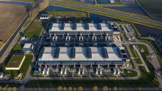 Aerial view of the imposing data center complex stands in stark contrast to the surrounding greenery, Agriport, Middenmeer, Netherlands.