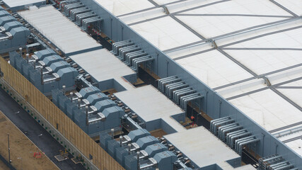 Aerial view of a newly built datacentre in Waltham Cross, highlighting AI-driven cloud computing infrastructure with close-up views of emergency backup generators and advanced cooling systems.