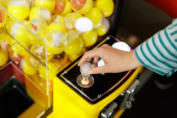 Hand operating yellow capsule toy vending machine