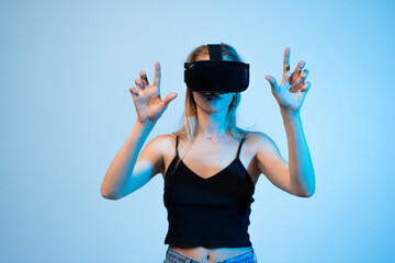 Woman using virtual reality headset with hand gestures, immersive VR technology and futuristic digital experience
