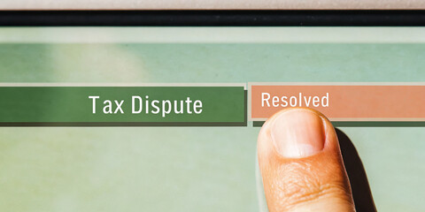 Close up of finger touching digital screen, changing status from tax dispute to resolved, symbolizing financial relief and successful resolution
