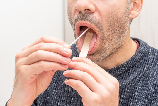 Man doing portable streptococcus bacteria test analysis, patient pours solution
