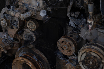 Burnt out car engine in Ukraine. after a fire or accident scene, covered with rust.