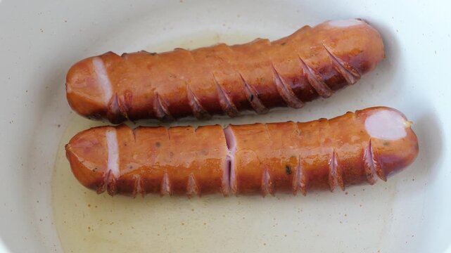 Frying sausages at the frying pan