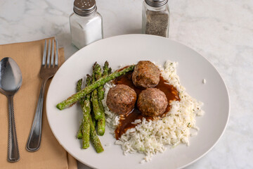  meatballs on rice and gravy with roasted asparagus