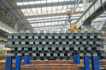 Close up photo of steel ingots stacked in the production workshop of a steel plant