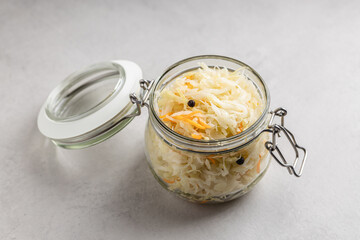 Pickled cabbage. Sauerkraut with carrots in a glass jar.