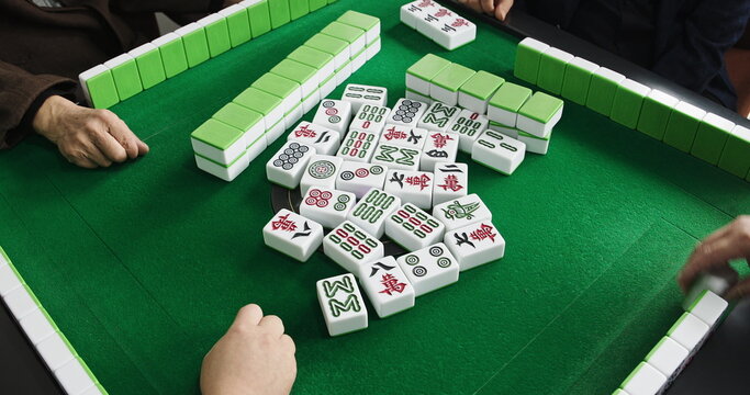 Chengdu, Sichuan, China. Men Playing Mahjong At Automatic Mahjong Table. Friendly Playing. People Playing Mahjong. Hands Of Mahjong Players. Live Game, Close Up View. Asian Culture. Travel China