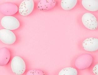 Pastel Easter eggs frame on pink background with soft spring colors and copy space