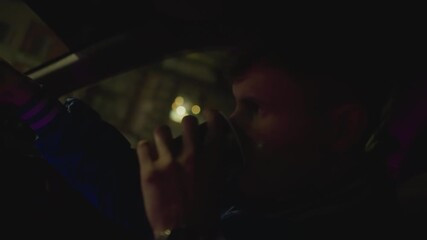 night driver portrait, drinking from cup, focused silhouette behind wheel with neon reflections, urban streets passing outside, quick sip between stops, quiet introspection and candid documentary vibe
