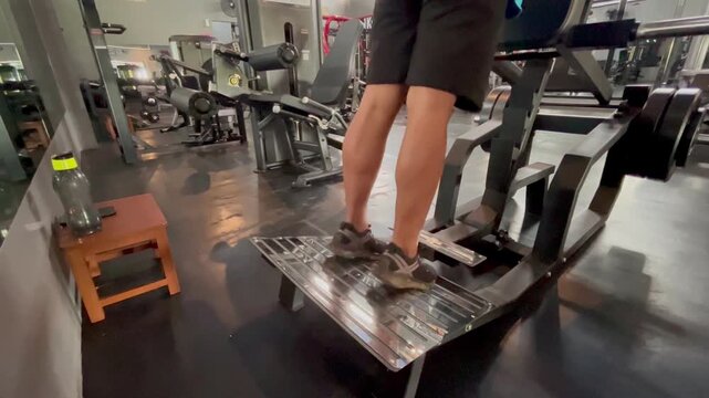 a man who is training his leg muscles at the gym