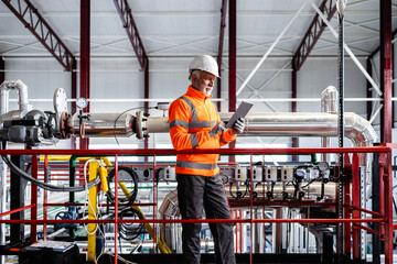 Senior engineer checking data on tablet in industrial plant