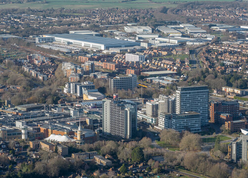 Aerial view of buildings casting shadows under a winter sky, with the distinctive spire of a church contrasting against modern architecture, Basingstoke, England, United Kingdom.