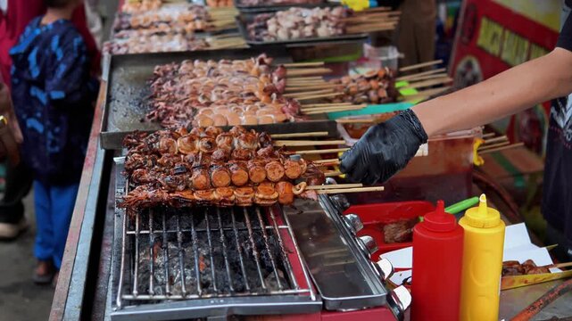 Grilling Bakso Meatball Skewers at Street Food Stall