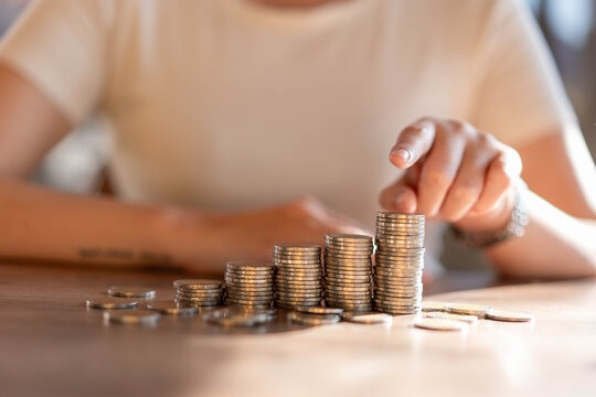 The woman pointed to a pile of silver coins with her hand.
