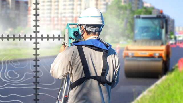 Road surveying and geodesy. Surveyor measures road alignment with a total station while asphalt compaction machinery operates, supporting infrastructure planning and construction control.