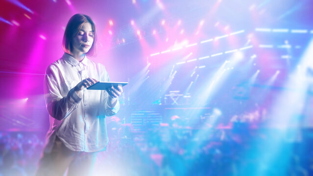 Live event management, show coordinator uses tablet to control stage lighting and concert visuals, supporting performance programming, audience experience and production workflow.