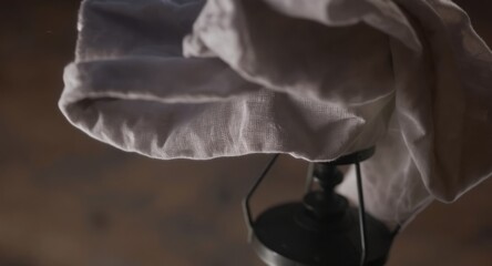 White cloth draped over dark metal fixture