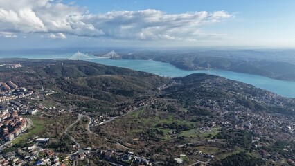 Aerial view of the Yavuz Sultan Selim Bridge spanning the Bosphorus Strait under a dramatic sky, Istanbul, Turkey.