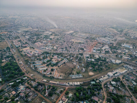 Aerial view of buildings clustered together, interspersed with green trees and roads cutting through the landscape, Kaduna, Kaduna, Nigeria.