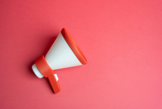 Megaphone on a red background. Marketing and advertising. High visibility promotion concept, urgency messaging, aggressive campaigns and emotional impact on audience attention and buying behavior