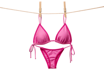 Pink string bikini hanging on clothesline with pins, isolated on a transparent background